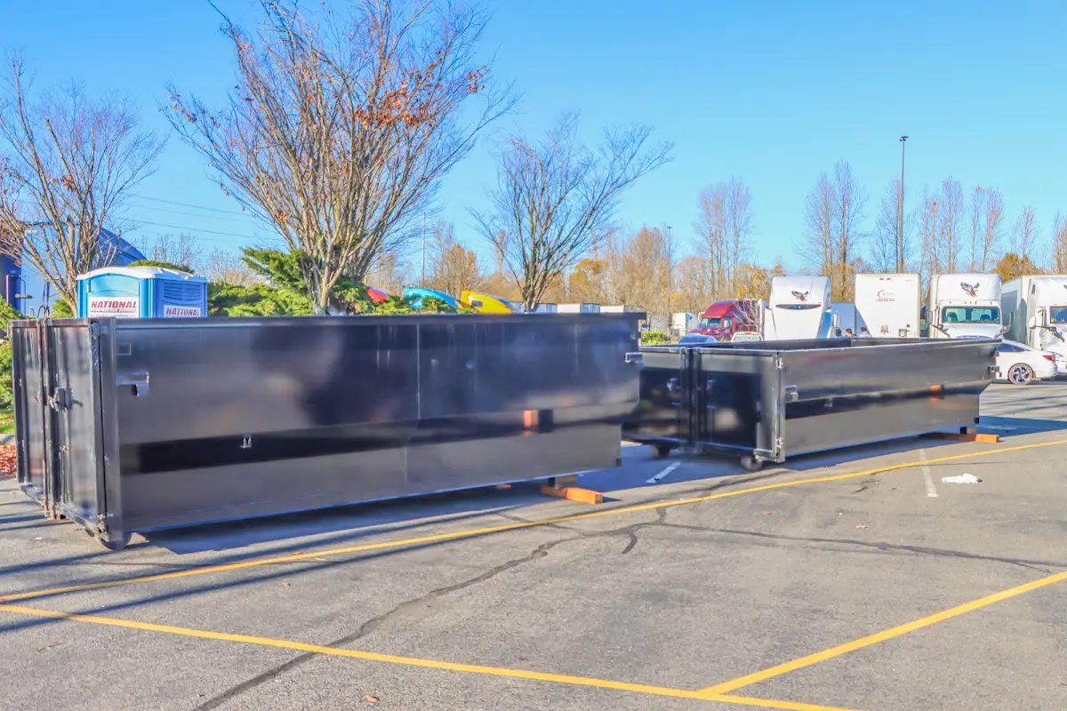 Professional dumpster rental service with roll-off container on residential driveway in Deer Park